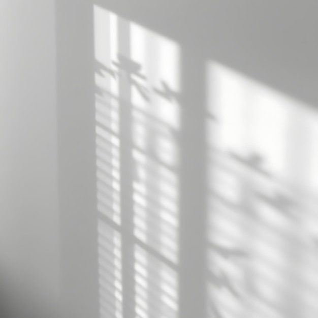 a window with the sun shining through the blinds