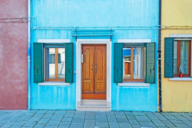 Windows and door in a blue house facade