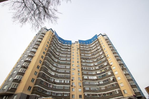 Windows of multistorey tall building against background of sky