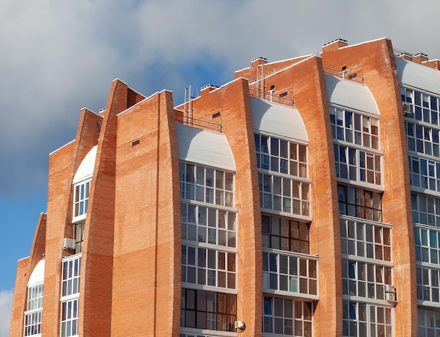 Windows of a residential multi-storey brick house. Modern buildings. The new multi-storey apartment