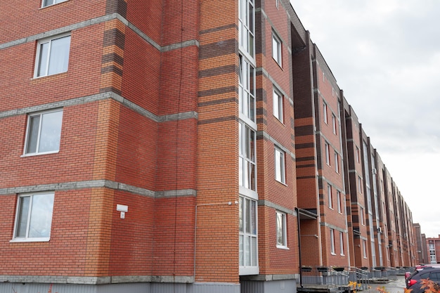 Windows of a residential multi-storey brick house. Modern buildings. The new multi-storey apartment