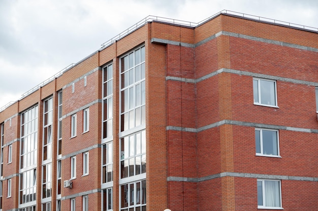 Windows of a residential multi-storey brick house. Modern buildings. The new multi-storey apartment