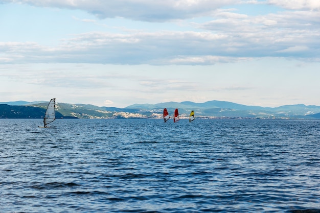 Windsurfers in the lagoon against the backdrop of a beautiful sky