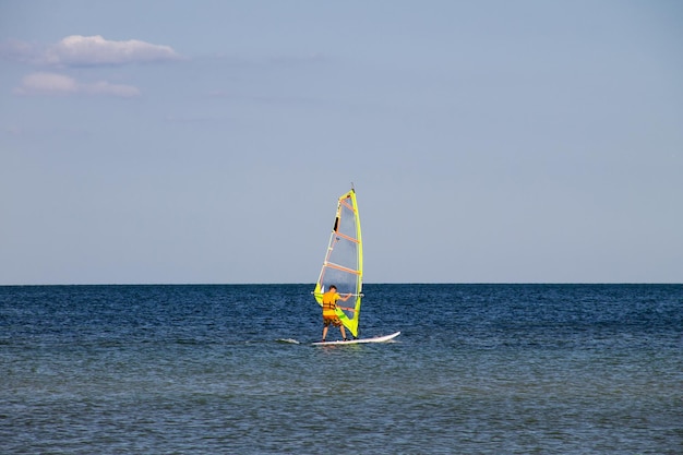 Windsurfing Surfer exercising in calm sea or ocean