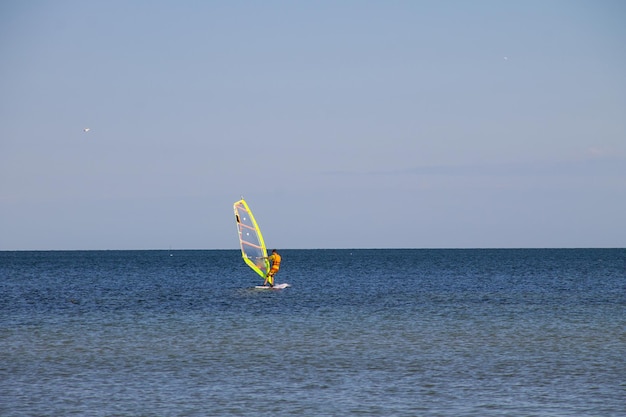 Windsurfing Surfer exercising in calm sea or ocean