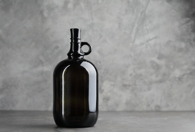 Wine bottle on a concrete background. Free space for inscription.