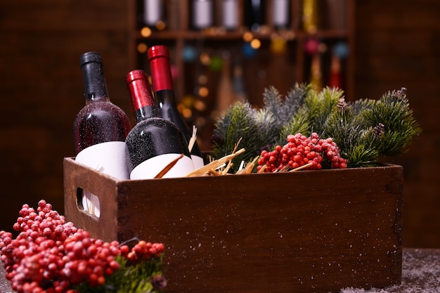 Wine bottles in decorated box on unfocused surface