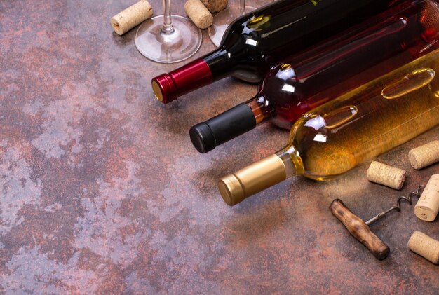 Wine bottles and glass on table with copy space, background