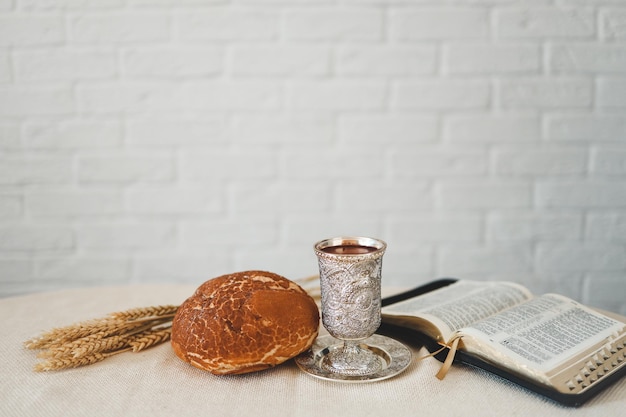 Wine bread and open bible communion concept