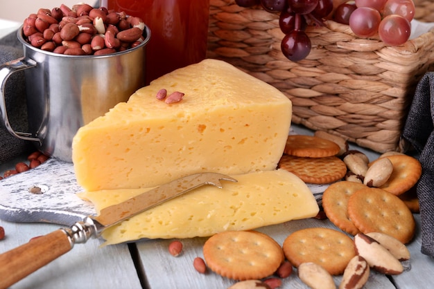 Wine cheese and crackers on wooden table closeup