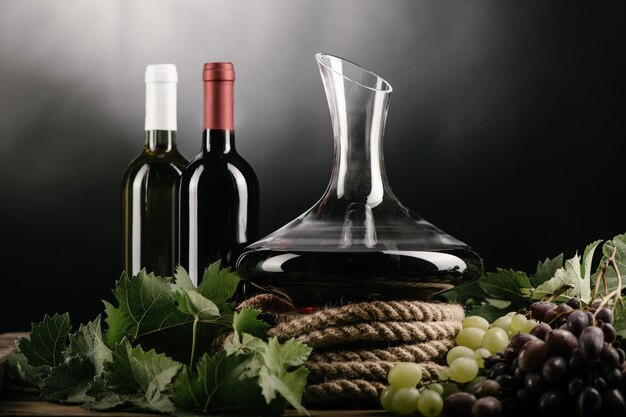 Wine decanter bottle glass of red wine and grapes