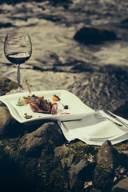 Wine glass and meal near water