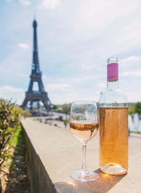 Wine in a glass near the eiffel tower Selective focus