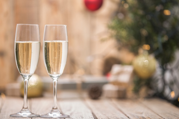 Wine glasses in front of a Christmas tree