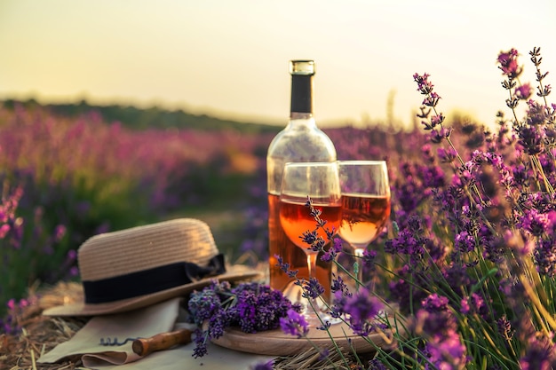 Wine in glasses. Picnic in the lavender field. Selective focus. Nature.