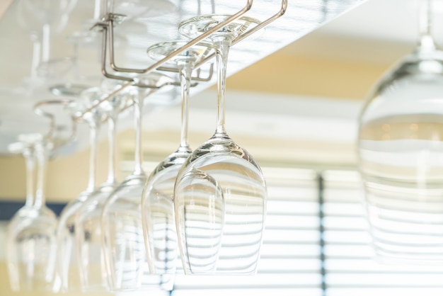 Wine's glass hanging on bar.