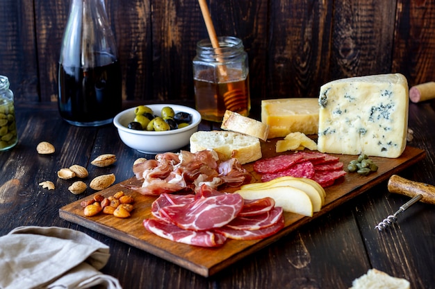 Wine snack. Prosciutto, Parma ham, salami, almonds, olives, baguette, blue cheese, parmesan. Antipasti.