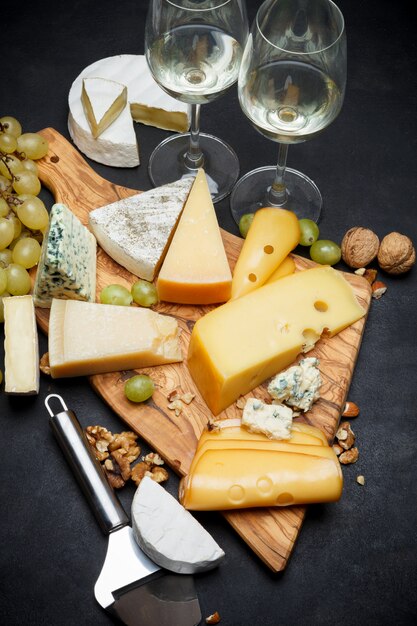 Wine and Various types of cheese - parmesan, brie, roquefort, cheddar