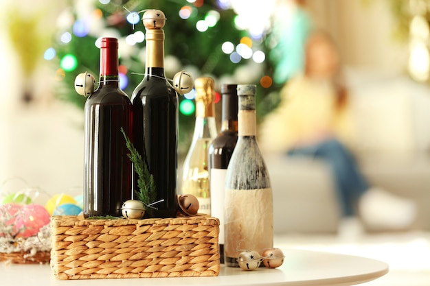 Wine in wicker box and Christmas decor in a room