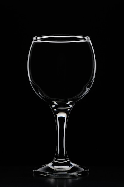 Wineglass consecrated by white silhouette light with reflection