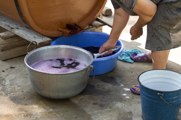 The winemaker pours grape juice for transportation into barrels