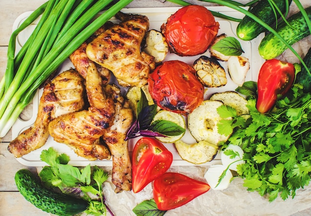 Wings and grilled vegetables. selective focus.