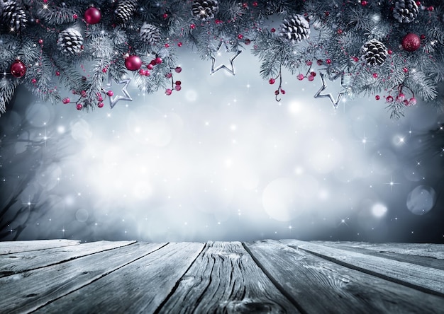 Photo winter background with frost fir branch and wooden planks