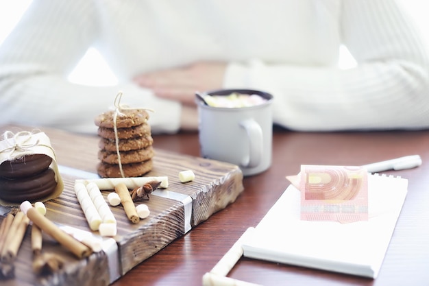 Winter breakfast. A cup of hot chocolate with marshmallows and freshly baked cookies. Gingerbread cookie and coffee.