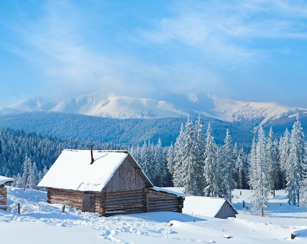 Winter calm mountain landscape with shed and mount ridge behind Kukol Mount Carpathian Mountains Ukraine