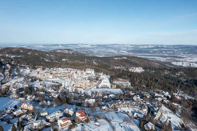 Winter city among the forest in the mountains View of the winter landscape from a drone Karpacz Poland