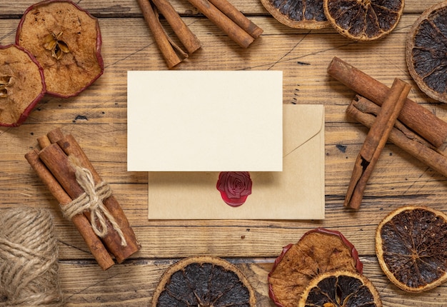 Winter Composition with a blank card and sealed envelope spices and dried fruits