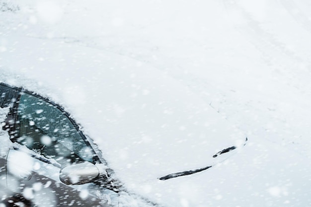 Winter Driving Tips How to Clear Ice and Snow from a Car Windshield with a Scraper Car exterior covered with fresh snow Heating up car before trip Idling engine