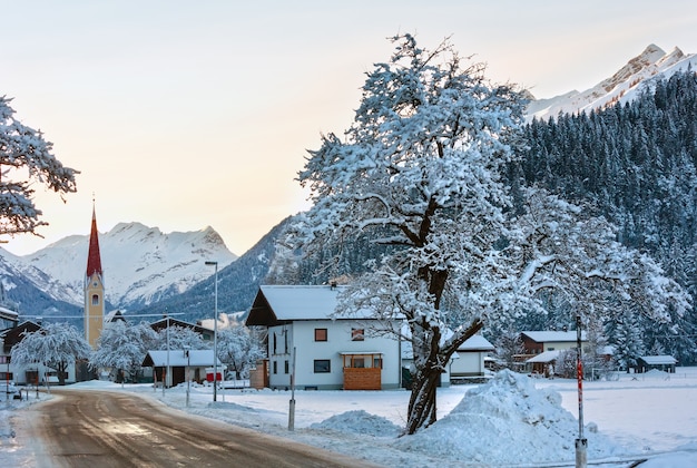 Winter evening mountain village view and snowy trees (Austria, Tyrol).