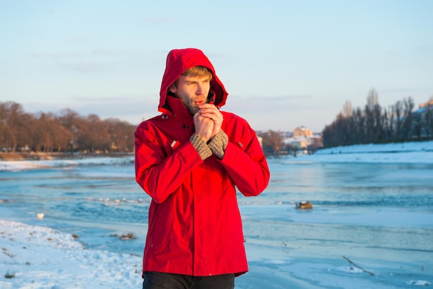 Winter flu. Flu and cold. love winter nature. man in red parka. winter male fashion. warm clothes for frost. chill weather forecast. human and nature. man enjoy snowy landscape in sunset.