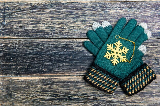 Winter gloves on wooden background. Christmas decoration