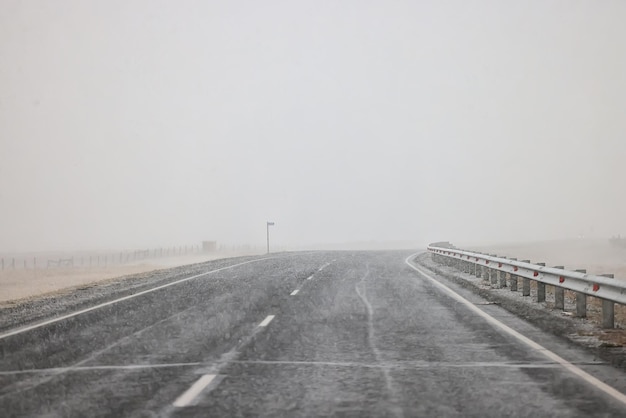 winter highway snowfall background fog poor visibility