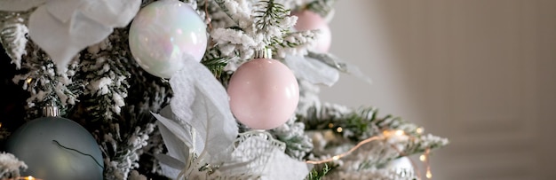 Winter holiday composition christmas tree fir branches silver balls pink pastel ornaments christmas