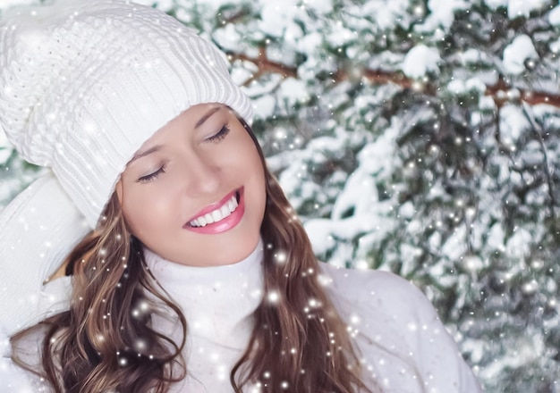 Winter holiday travel lifestyle and fashion beautiful happy woman and snowy forest nature ski resort and leisure activity outdoors Christmas New Year and holidays portrait