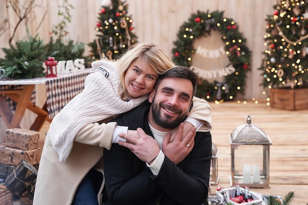 Winter holidays and celebrations Christmas couple in love near Christmas tree outdoors