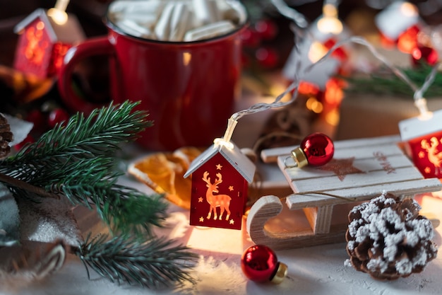 Winter hot cocoa with marshmallows in Christmas cup