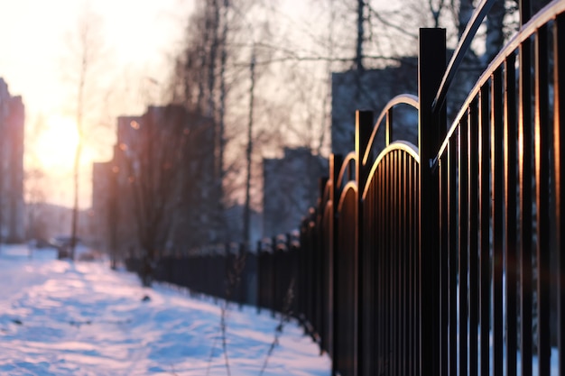 Winter landscape iron fence at sunset