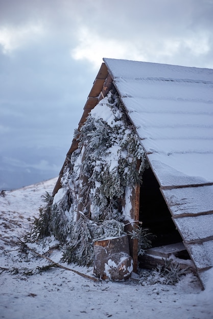 Winter landscape. Little wooden shelter in the mountaines
