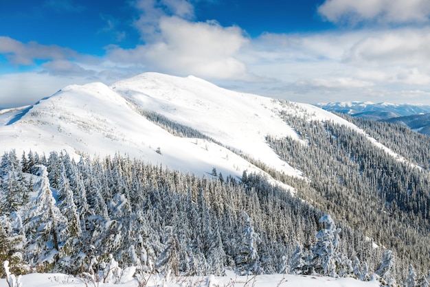 Winter landscape in mountains with snow and blue hills