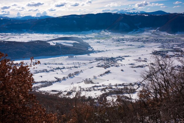 Winter landscape valley and hills covered with snow on bright sunny day