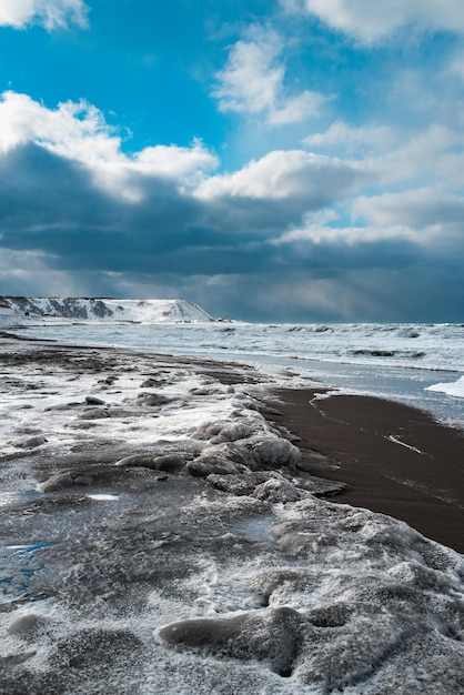 Winter landscape with frozen sea and icy beach dramatic seascape storm and snow weather