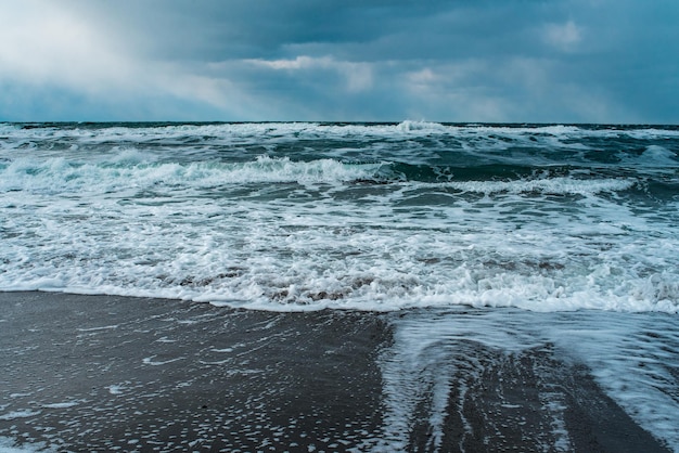 Winter landscape with frozen sea and icy beach Storm and snow weather Dramatic seascape