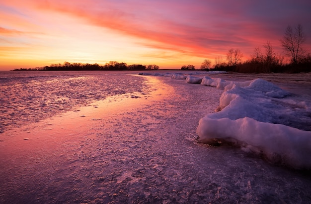 Winter landscape with sunset fiery sky. Composition of nature.