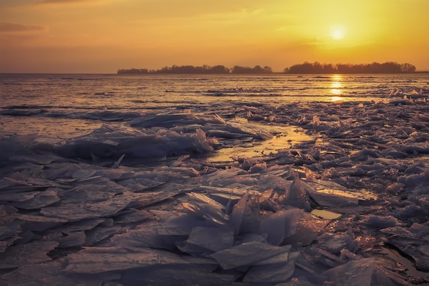 Winter landscape with sunset sky and frozen sea coast Daybreak