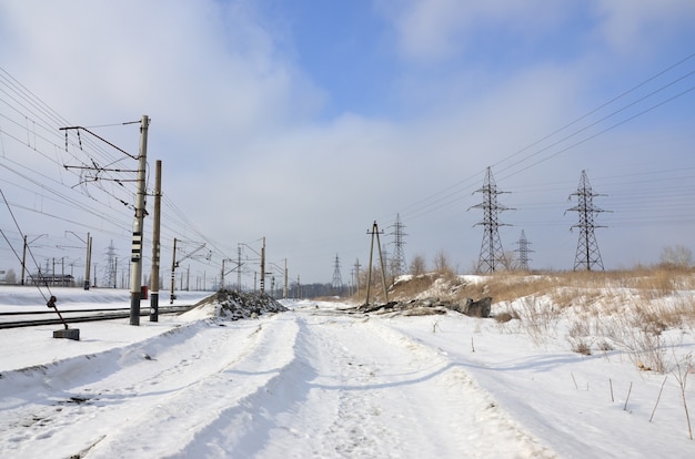 Winter landscape with towers of transmission lines