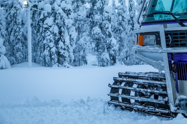 Photo winter. a lot of snow. snowcat stands on the edge of the forest